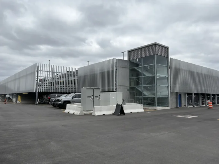 Corner view of the Reagan National Airport relocatable parking deck showing the glazed stair tower and vertical fin facade.